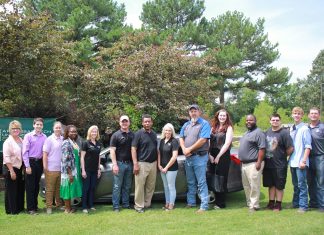 Local Dealerships Donate Car to ATCC Career Center staff and students stand in front of a donated vehicle