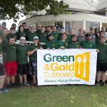 Summer Drive for Cupboard June 10-18 Students and faculty proudly display the Green & Gold Cupboard banner