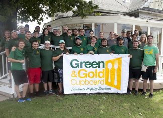 Summer Drive for Cupboard June 10-18 Students and faculty proudly display the Green & Gold Cupboard banner