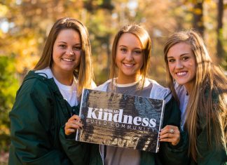 Giving Back: ATU Students Go Above and Beyond Three female students dressed in ATU garb hold a sign that states "Spread Kindness Build Community"
