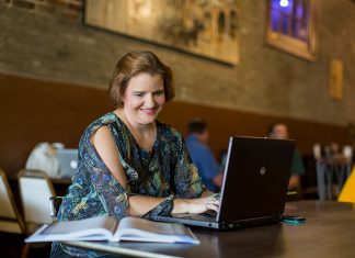 ATU Top 2 Nationally in Affordable Online Learning A non-traditional student works on a laptop in a cafe