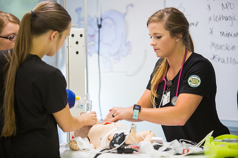 Nursing students are seen practicing resuscitation procedures