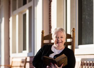 Lessons From a Front Porch Faculty member Jan Jenkins sits in a rocking chair on the porch of the Ross Pendergraft Library and Technology Center