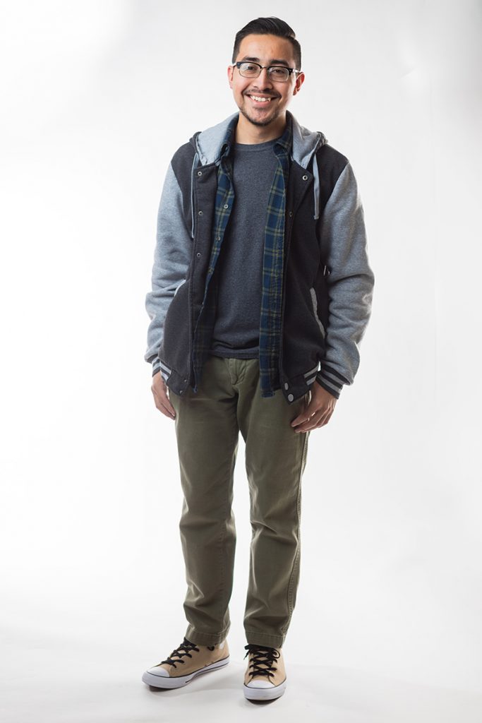 Student Elmer Evangelista is featured against a white backdrop wearing glasses and casual attire Student Elmer Evangelista is featured against a white backdrop wearing glasses and casual attire