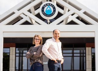Denali Water Solutions Dr. Julie Mikles-Schluterman and Andy McNeil stand in front of the Denali Water Solutions office