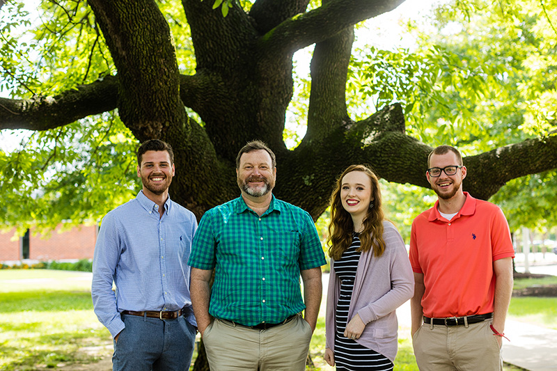Dr. Rodney Roosevelt stands with his students beneath an oak tree Dr. Rodney Roosevelt stands with his students beneath an oak tree