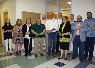 Green and Gold Cupboard Opens at Ozark Campus Ozark faculty and staff participate in a ribbon cutting