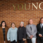 A Family, A Building and An Enduring Legacy Young Family in Front of Young Building 2021