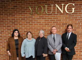 A Family, A Building and An Enduring Legacy Young Family in Front of Young Building 2021