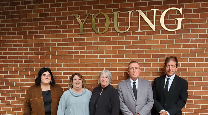 A Family, A Building and An Enduring Legacy Young Family in Front of Young Building 2021